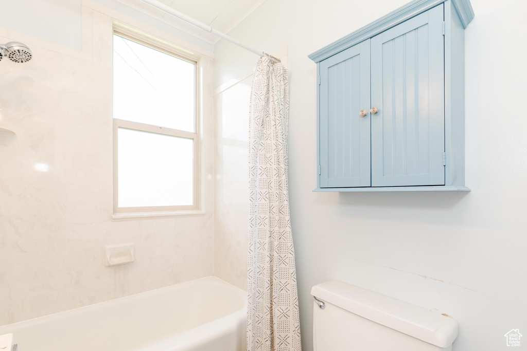 Full bathroom with toilet and shower / bath combo
