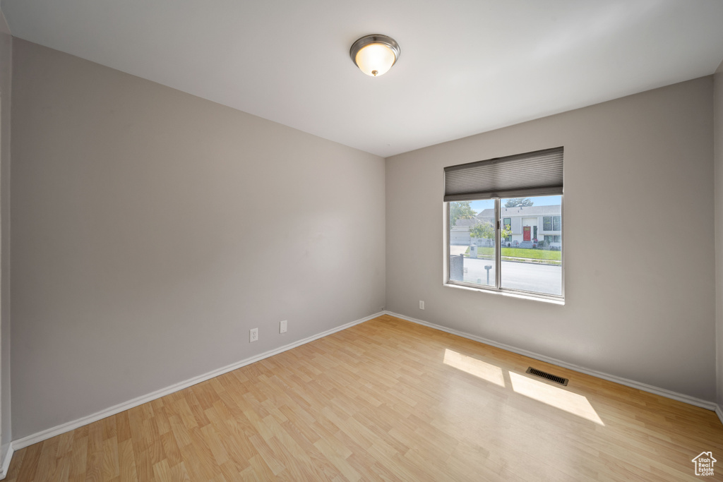Unfurnished room featuring wood finished floors and baseboards