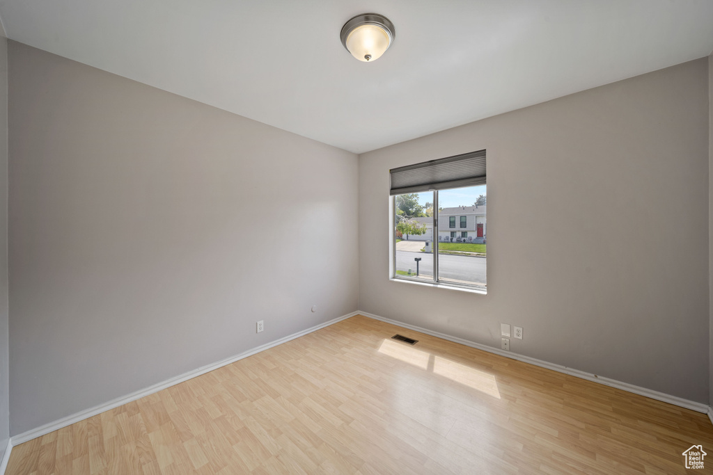Unfurnished room featuring baseboards and wood finished floors