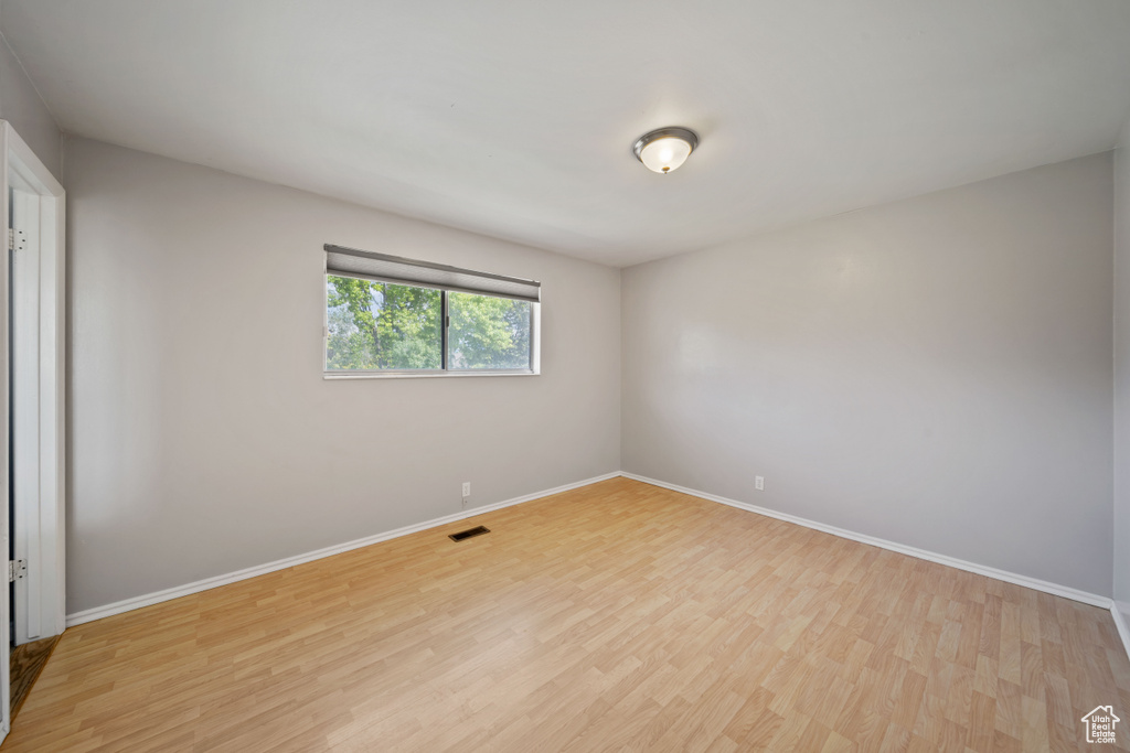 Empty room featuring light wood-style floors and baseboards