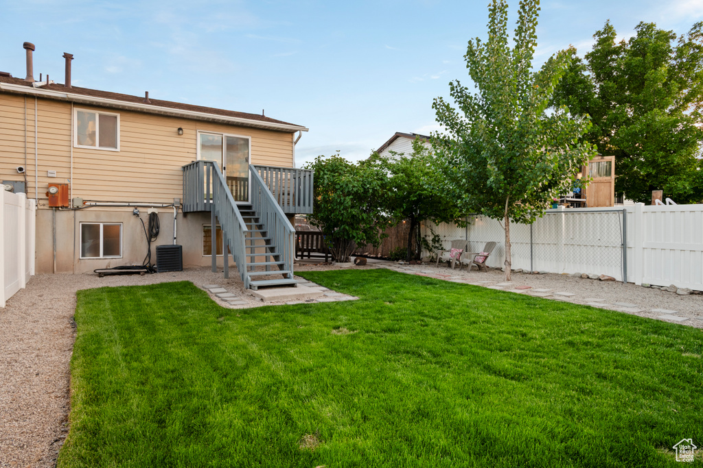 Rear view of house with central AC