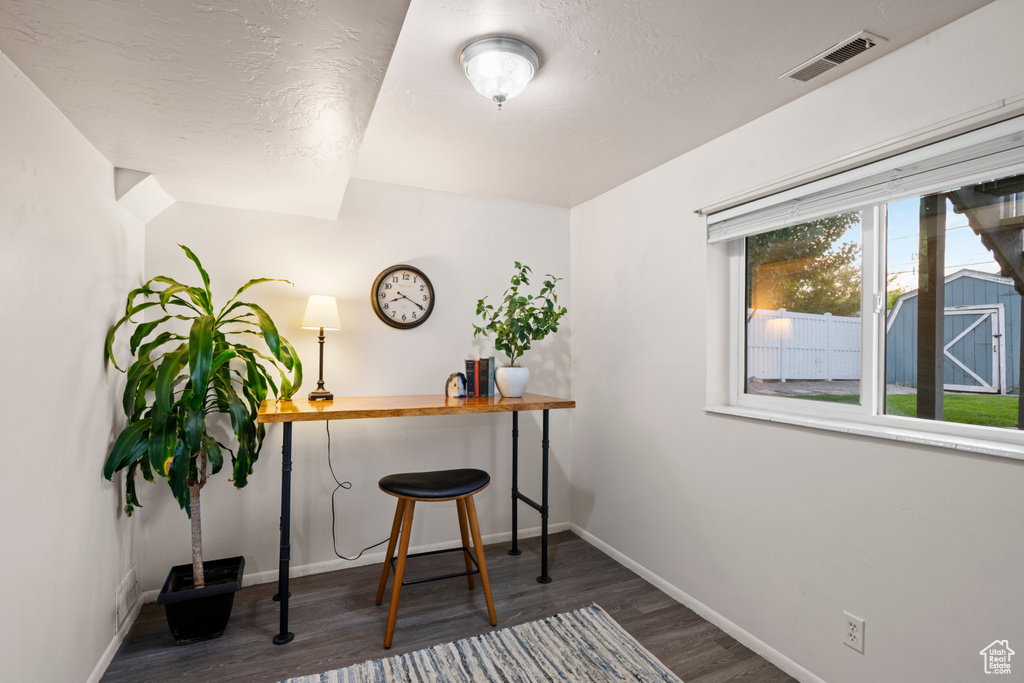 Office space with wood finished floors and baseboards