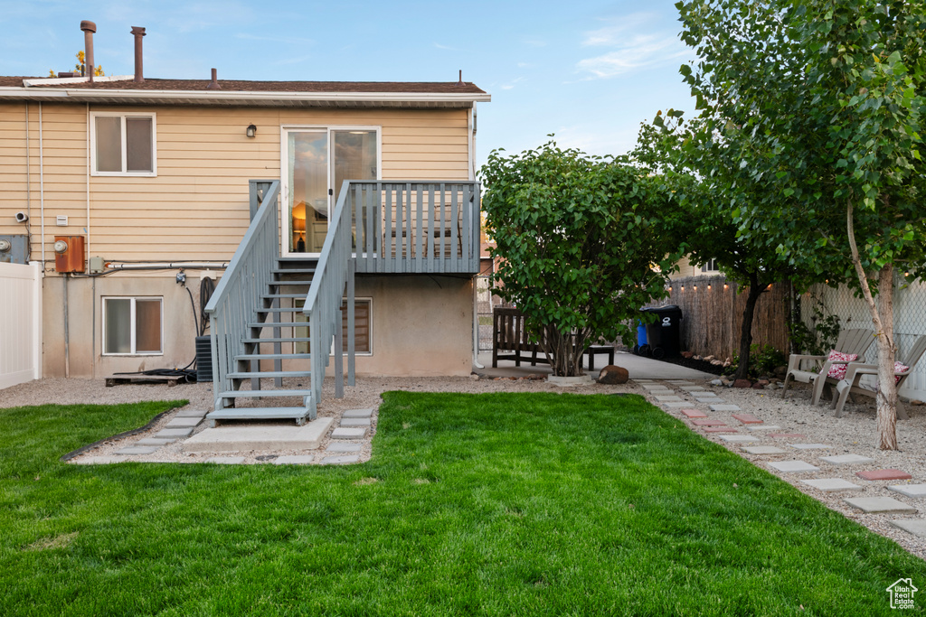 Back of property featuring stairway and a wooden deck