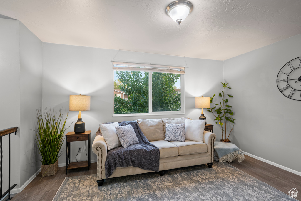 Living area with wood finished floors and baseboards