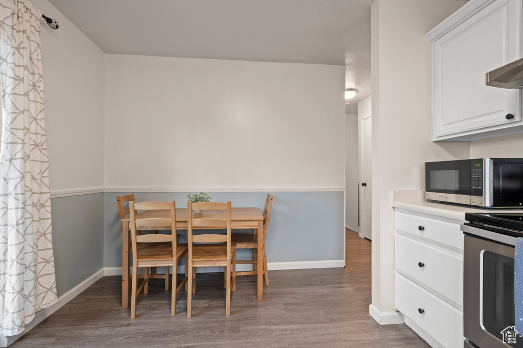 Dining room with wood finished floors and baseboards