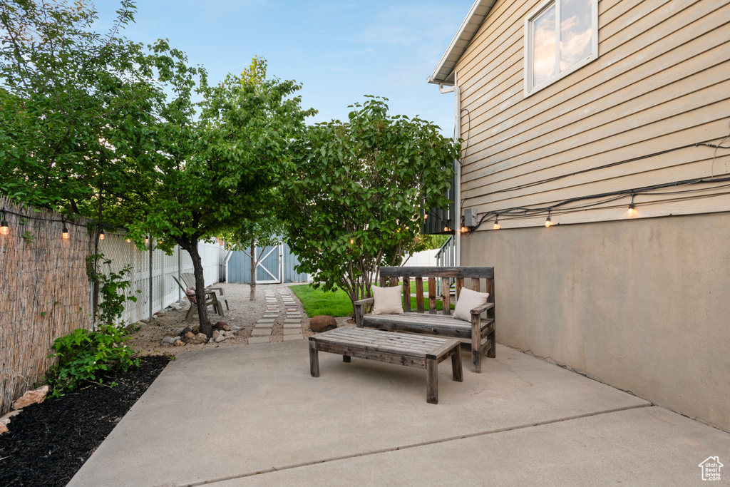 Fenced backyard featuring a patio area and a gate