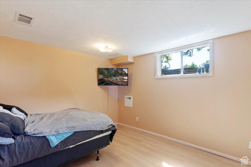 Bedroom featuring light wood finished floors and baseboards
