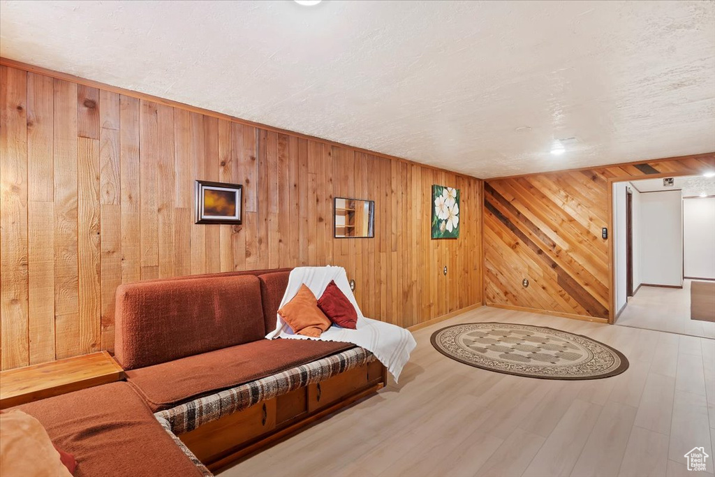 Sitting room featuring wood walls and wood finished floors