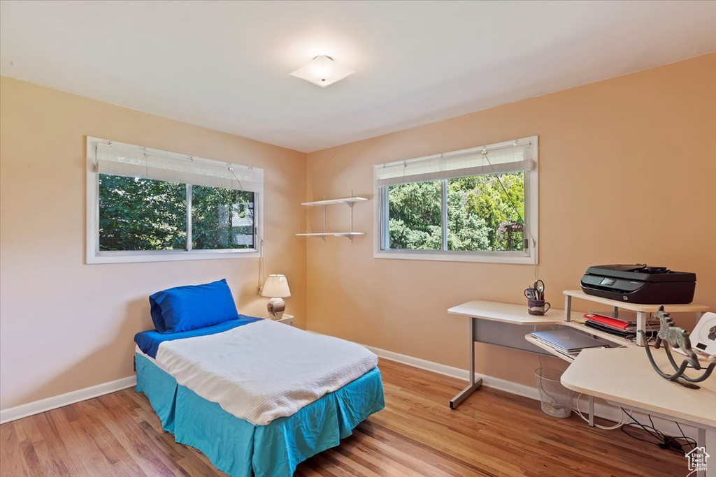 Bedroom with baseboards and wood finished floors