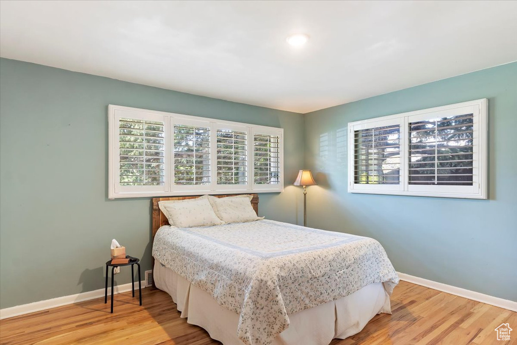 Bedroom with baseboards and light wood finished floors