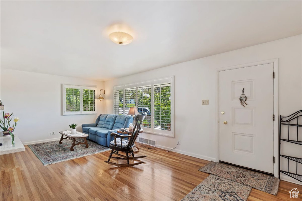 Living area with baseboards and wood finished floors