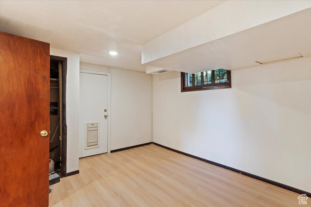 Below grade area featuring light wood-style flooring, baseboards, and recessed lighting