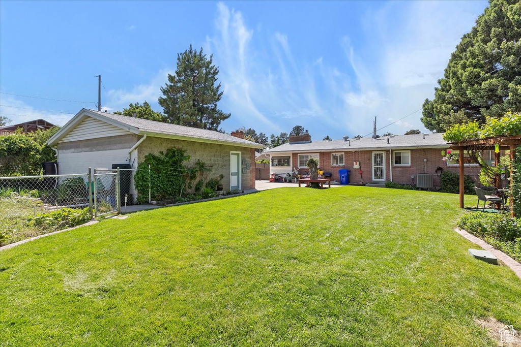 View of yard featuring central AC unit and a patio area