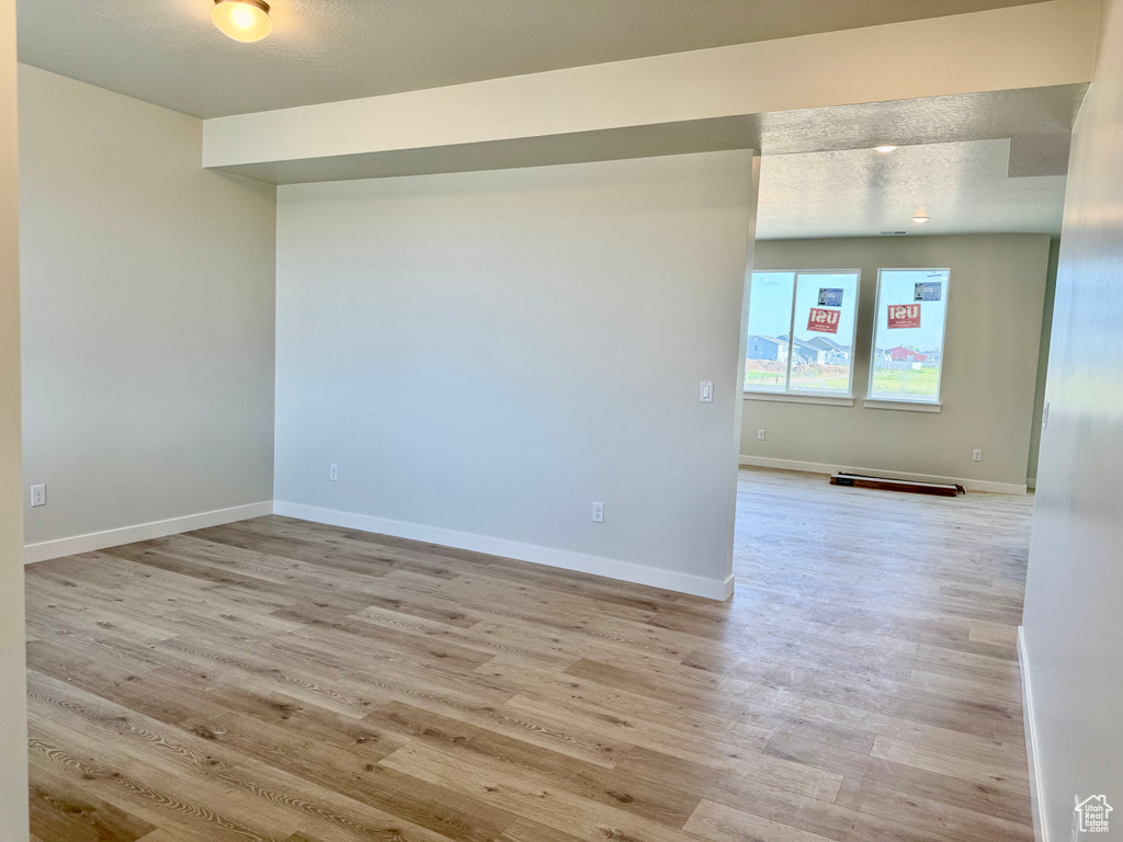 Spare room with light wood finished floors and baseboards