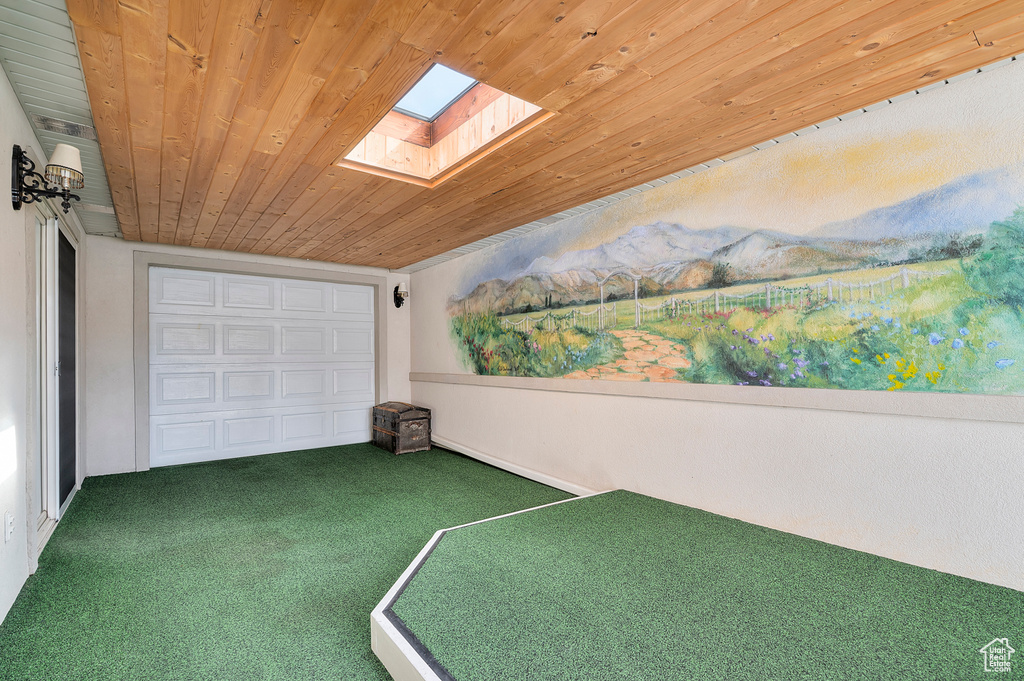Game room with carpet floors, wood ceiling, and a skylight