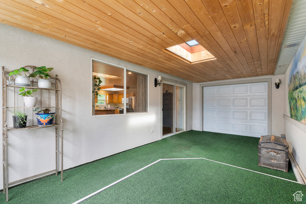 Unfurnished sunroom with a skylight