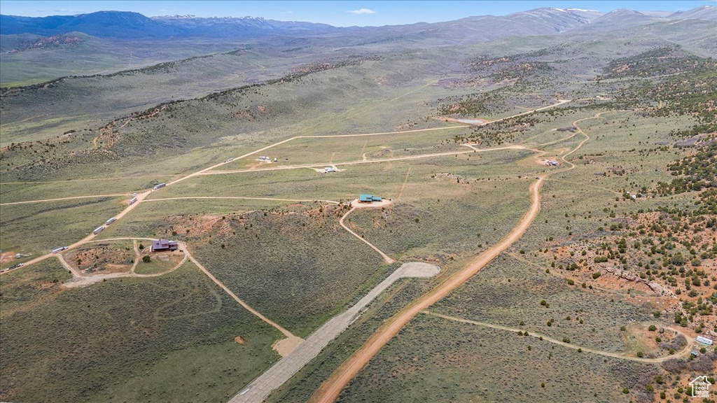 Aerial overview of property\'s location featuring rural landscape and a mountainous background