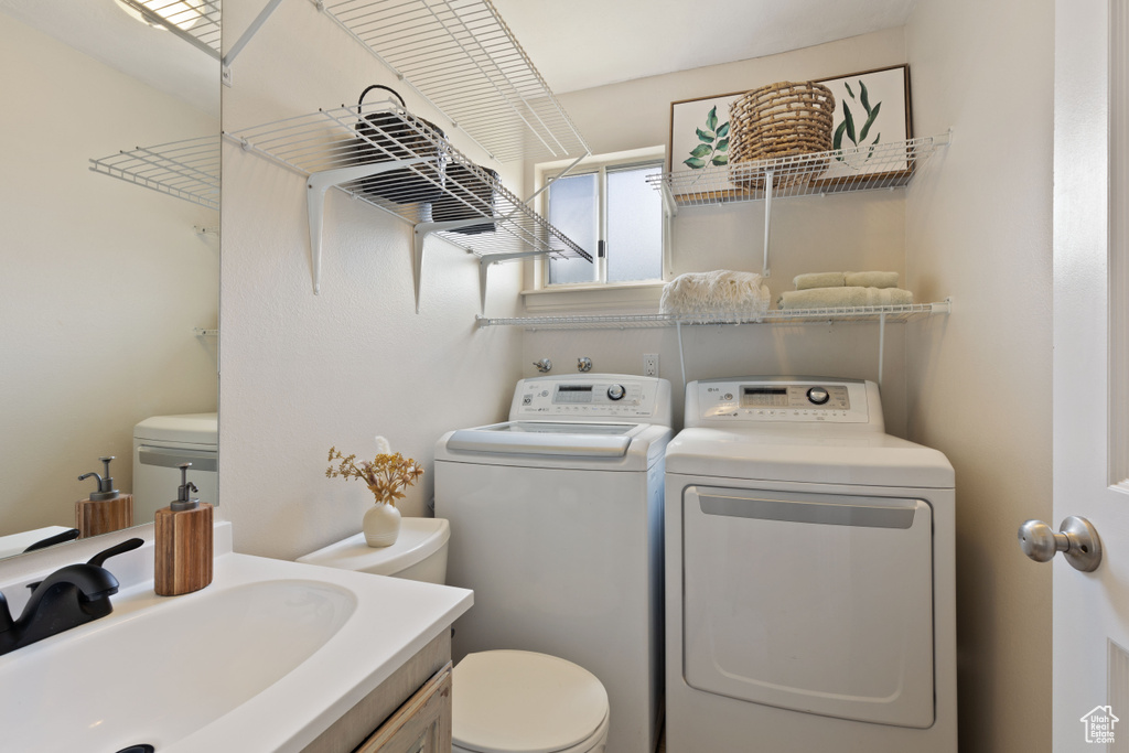 Washroom with washer and clothes dryer