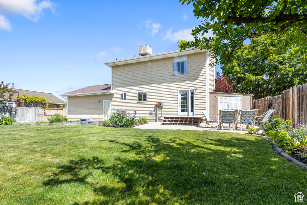Back of house with a patio and a chimney