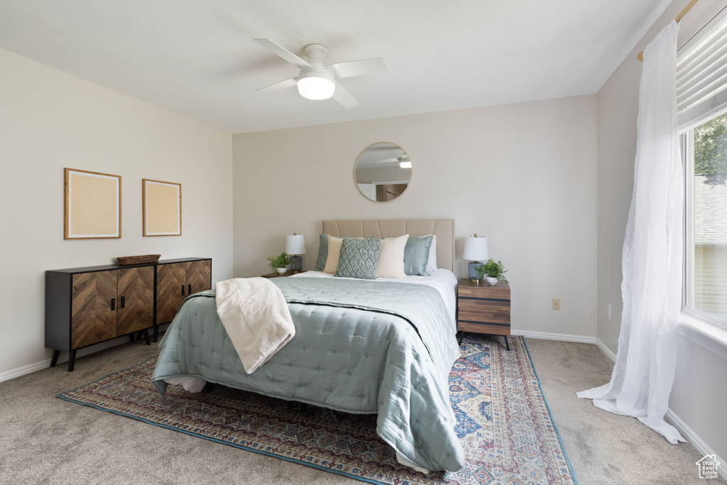 Bedroom with carpet, baseboards, and ceiling fan