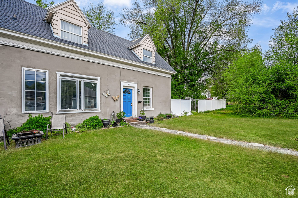 View of front of house with roof with shingles, entry steps, and stucco siding