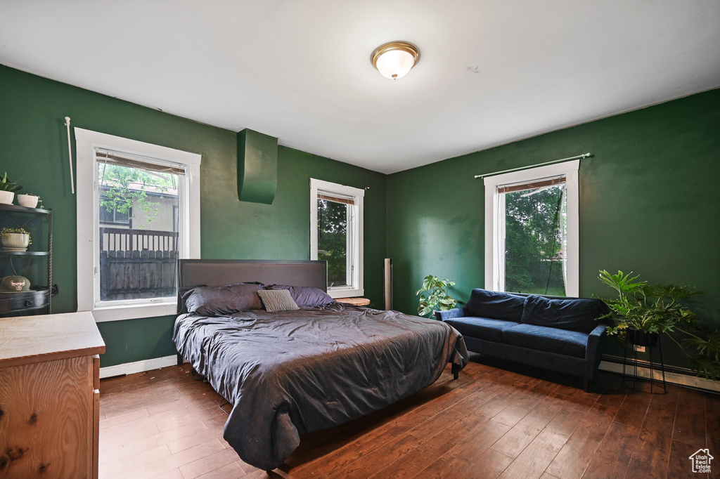 Bedroom featuring hardwood / wood-style flooring and baseboards