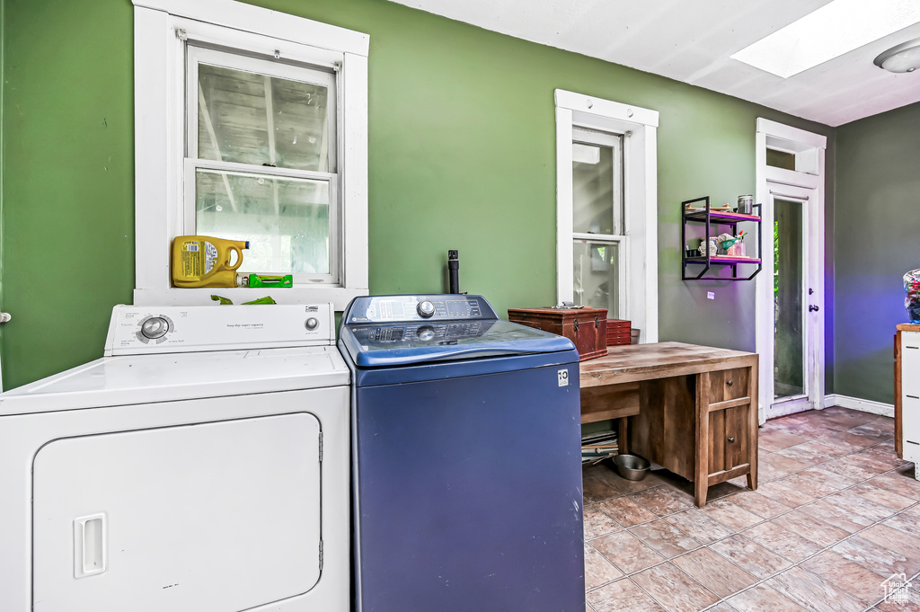 Laundry area with a skylight and washer and clothes dryer