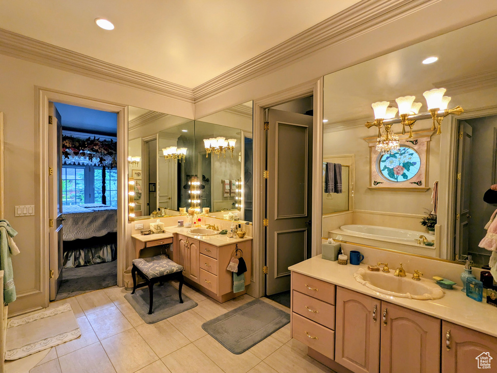 Ensuite bathroom with a chandelier, vanity, crown molding, tile patterned flooring, and a garden tub