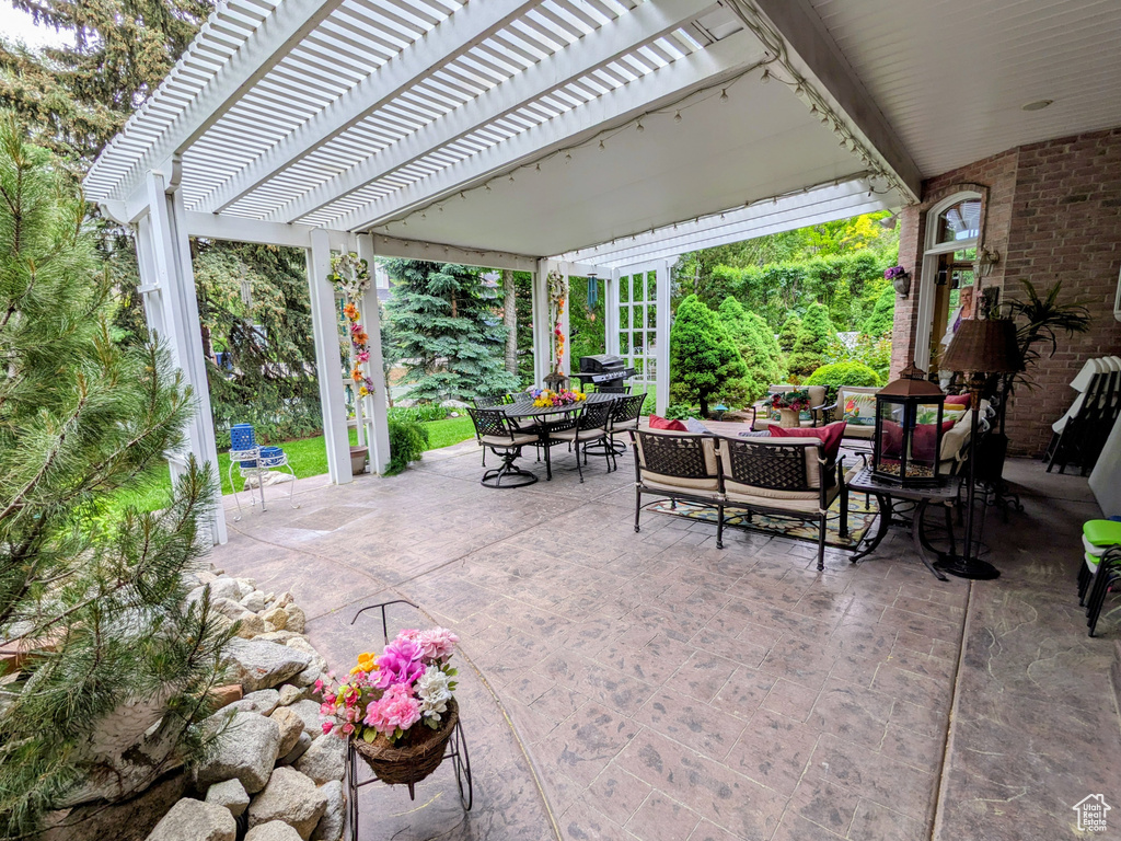 View of patio featuring outdoor dining space and a pergola