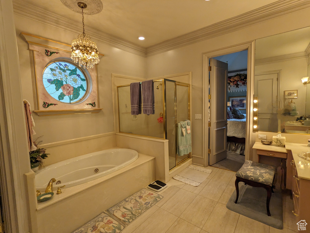 Full bath featuring a shower stall, a jetted tub, a chandelier, vanity, and crown molding