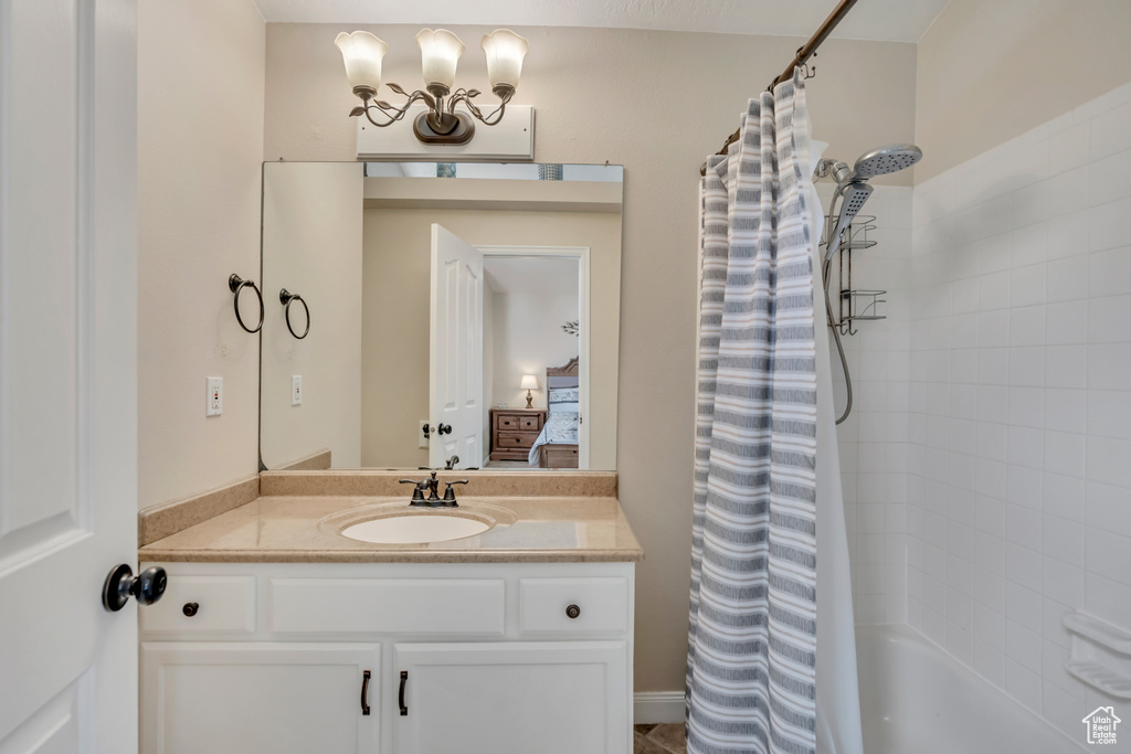 Ensuite bathroom with vanity and shower / tub combo with curtain