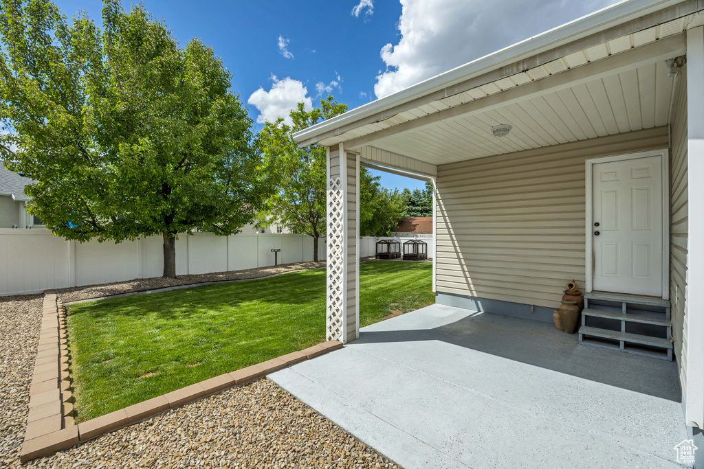 View of yard with entry steps and a patio