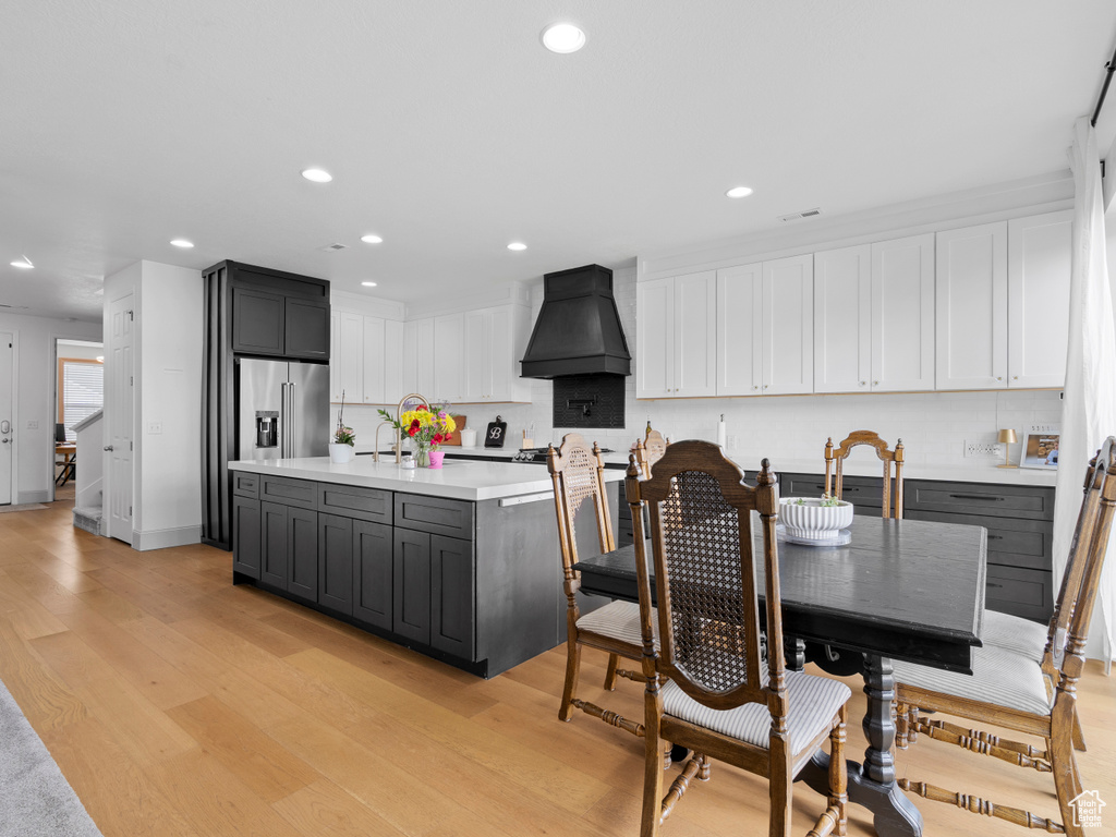 Dining area featuring light wood-type flooring and recessed lighting