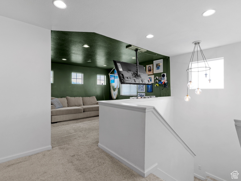 Hall with an upstairs landing, carpet flooring, recessed lighting, and baseboards