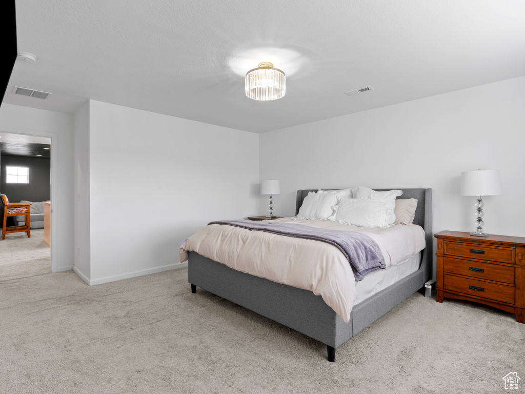 Bedroom with light carpet and baseboards