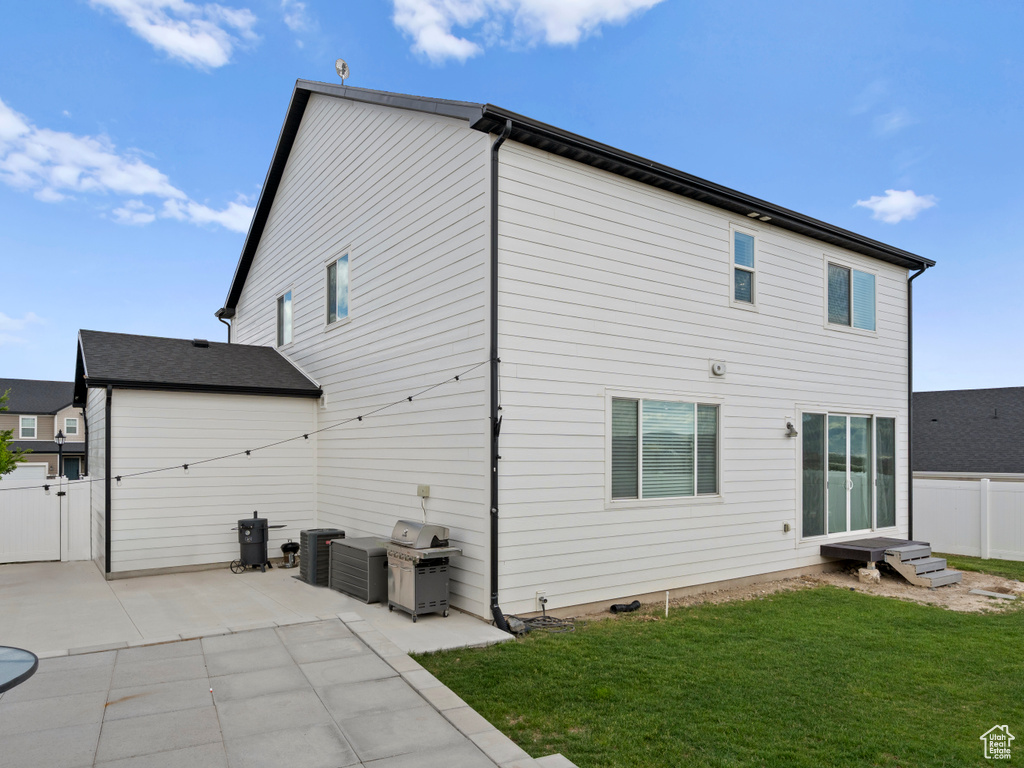 Back of house with a patio and central AC unit