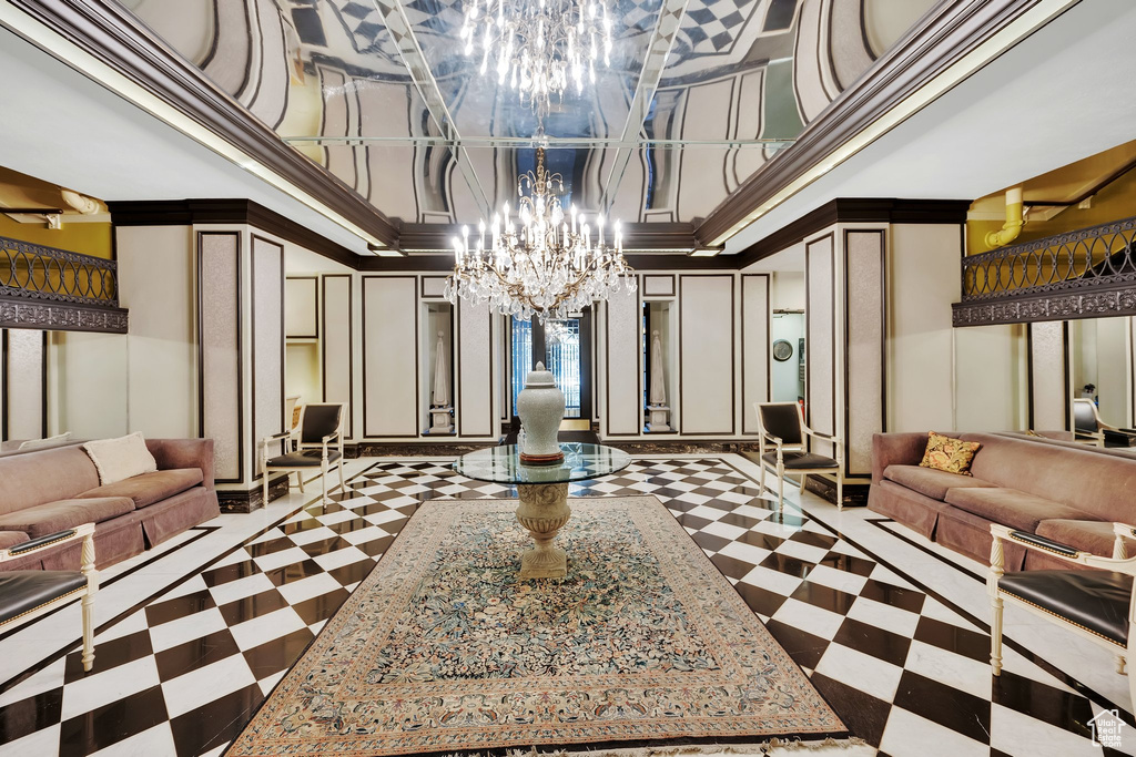 Common area featuring a decorative wall, a high ceiling, and crown molding
