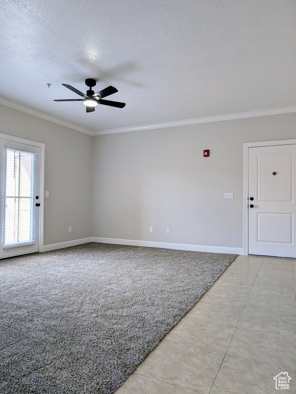 Unfurnished room featuring crown molding, ceiling fan, a textured ceiling, and baseboards