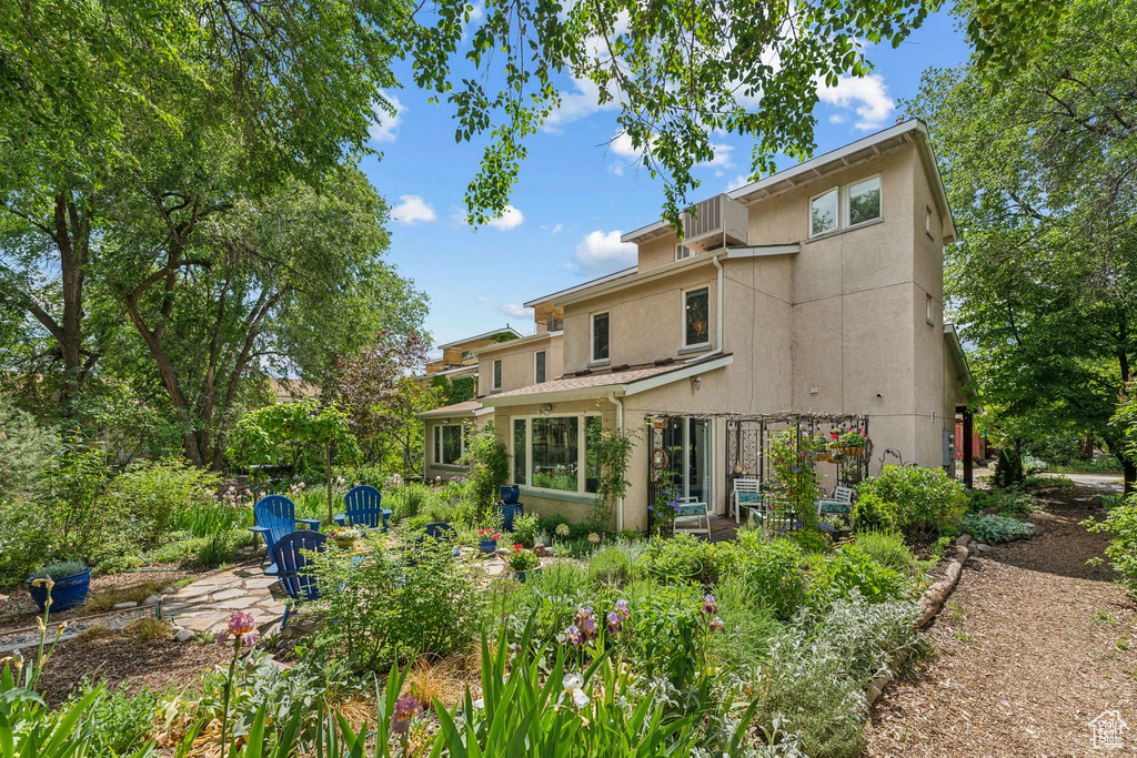 Rear view of property with stucco siding and a patio area