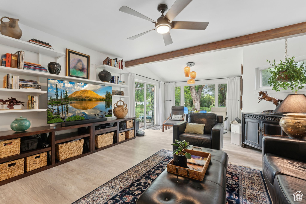 Living room with a ceiling fan and light wood-style floors
