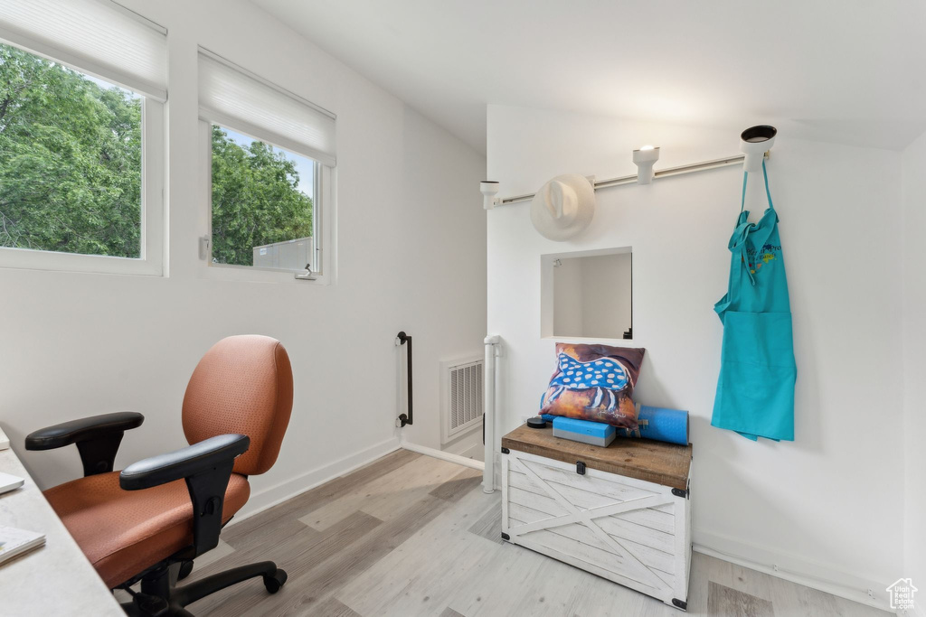 Home office featuring wood finished floors and baseboards