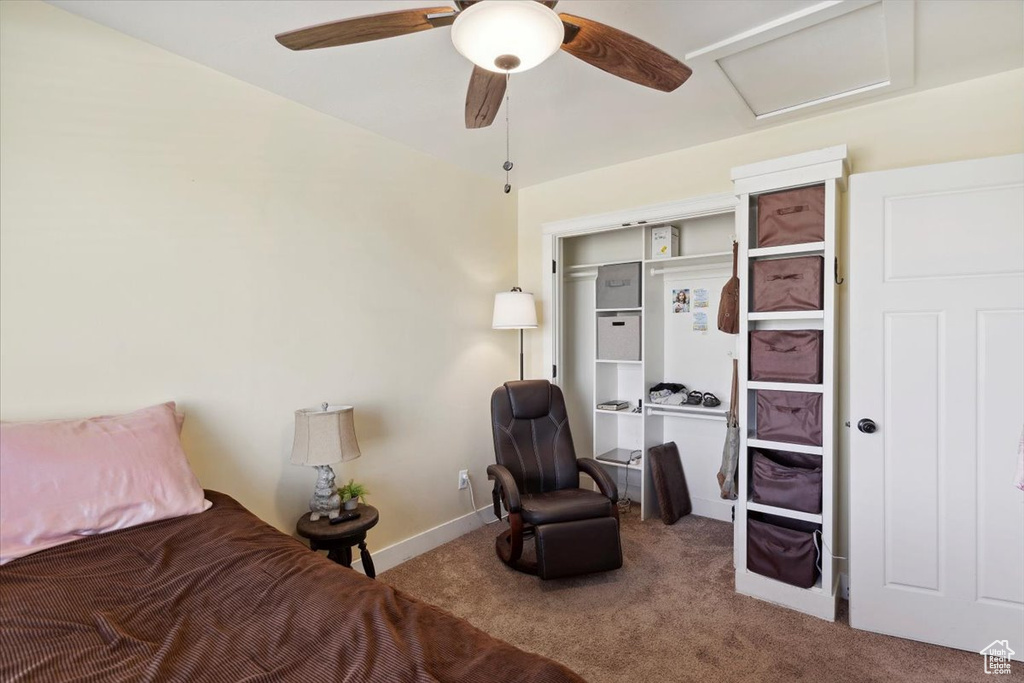 Bedroom with carpet flooring, attic access, baseboards, and ceiling fan
