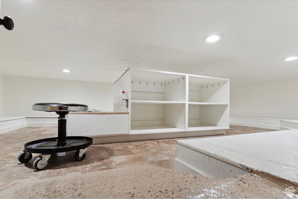 Detailed view of recessed lighting and baseboards