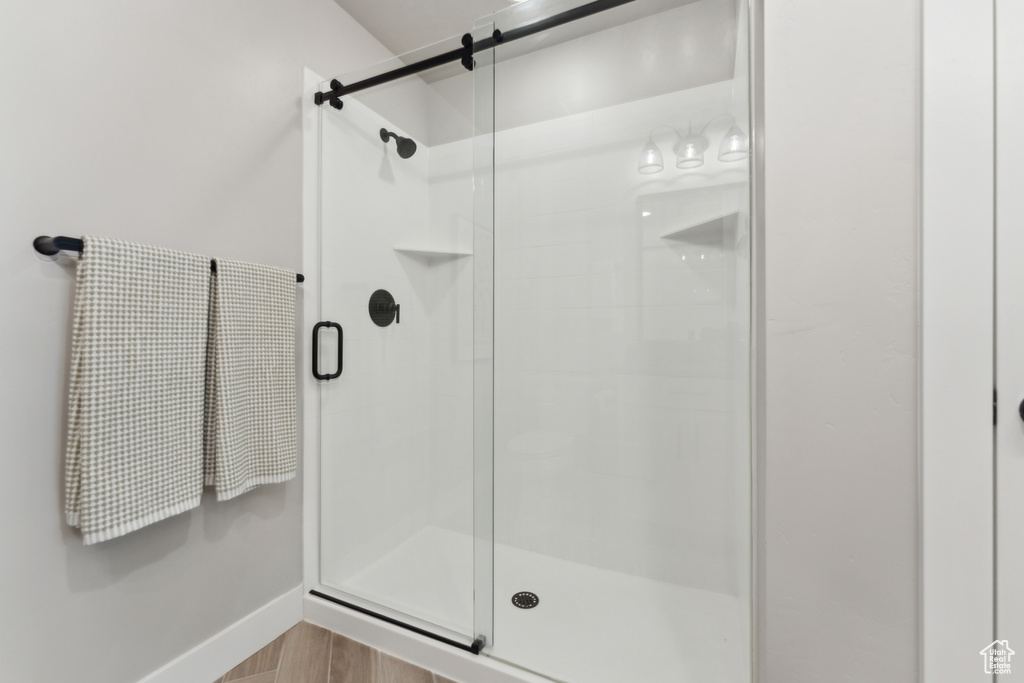 Bathroom with a stall shower and baseboards