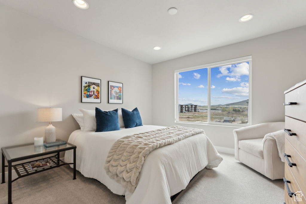 Bedroom with light carpet, recessed lighting, and baseboards
