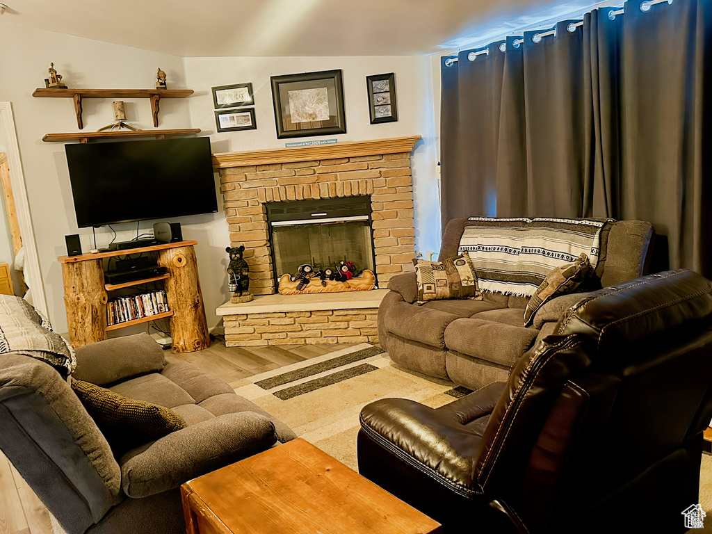 Living area featuring wood finished floors and a fireplace
