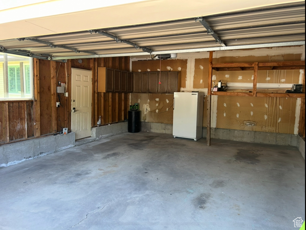 Garage featuring freestanding refrigerator