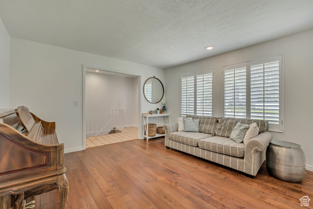 Living room with hardwood / wood-style floors and baseboards