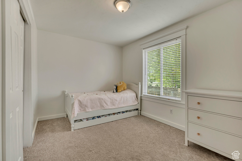Carpeted bedroom featuring baseboards