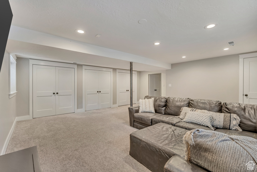 Living area featuring recessed lighting, light colored carpet, and baseboards